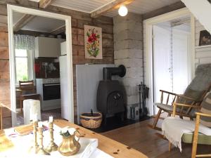 a kitchen and living room with a wood stove at Senja, Villa View in Senja +13 photos
