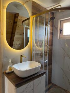 a bathroom with a white sink and a shower at Etno Selo Dolina Pive in Plužine