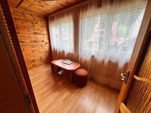 a small room with a table and a window at Smerekova Hata in Yablunytsya +141 photos