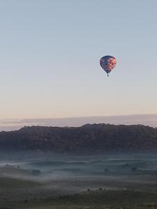a kite flying in the sky over a field at Na'raucária in Cambará