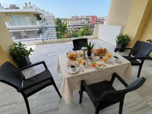 a table with fruit on it on a balcony at Elenas sweet home - Penthouse with Large Balcony in Pyrgos