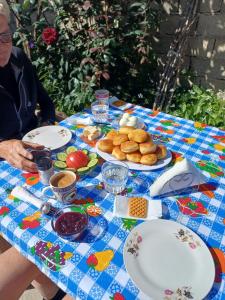 a table with plates of food on a blue and white table cloth at villa stavri in Pogradec