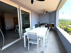 a white table and chairs on a balcony at Anai Jadranovo Sea View Penthouse in Jadranovo