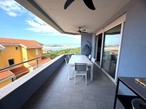 a balcony with a table and views of the ocean at Anai Jadranovo Sea View Penthouse in Jadranovo