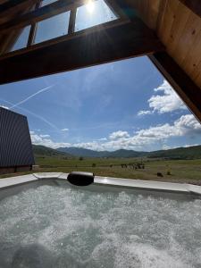 a view from the window of a hot tub at Etno Selo Dolina Pive in Plužine