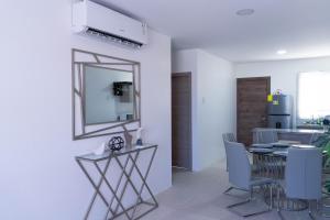 a dining room with a mirror and a table and chairs at Casa Rafaela in Santa Elena +12 photos
