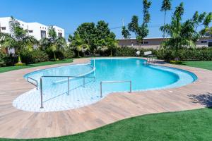 a large swimming pool in a yard with trees at Casa Rafaela in Santa Elena