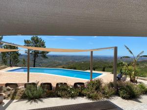 a swimming pool with a view of the mountains at Quinta O Ninho in Monchique +4 photos