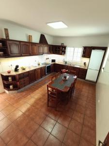 a large kitchen with a table and chairs in it at Dotty's House in Gaula