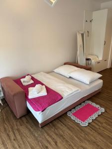 a bedroom with a bed with two towels on it at Apartament Różany 2 in Busko-Zdrój +8 photos
