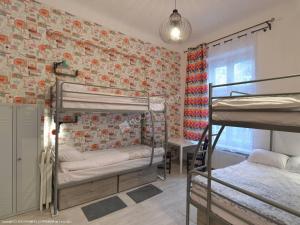 a bedroom with two bunk beds and a brick wall at Hostel Lwowska 11 in Warsaw