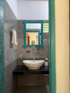 a bathroom with a sink and a mirror at Lobo's Retreat in Kurunegala
