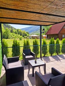 a patio with couches and a table with a view at Vila Petar Mokra Gora in Mokra Gora