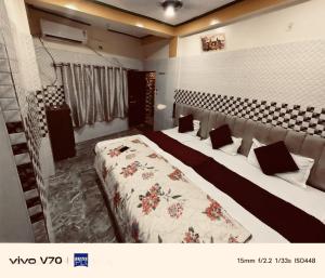 a hotel room with two beds in a room at Thakur JI Residency in Varanasi