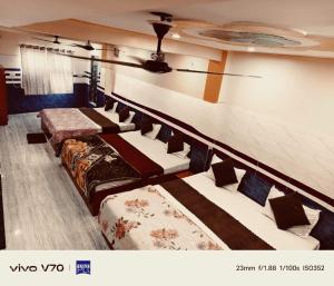 a row of beds lined up against a wall at Thakur JI Residency in Varanasi