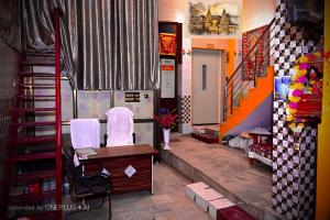a room with two chairs and a desk in a room at Thakur JI Residency in Varanasi