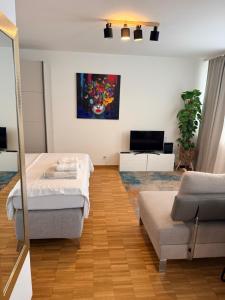 a bedroom with two beds and a couch and a painting at Piti in Lucerne +1 photo
