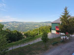 a house with tables and chairs on the side of a road at Ostello di Montefiorino in Montefiorino +1 photo