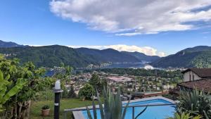 a villa with a view of a lake and mountains at Appartamenti Villa Colibri in Neggio