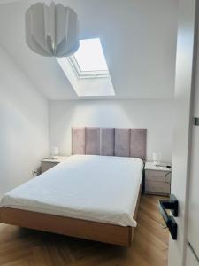 a bedroom with a bed and a skylight at Apartament Drohiczyńska in Siemiatycze