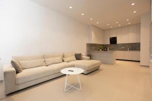 a living room with a couch and a table at Aria apartment 2 in Dhërmi