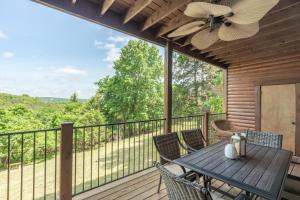 a deck with a table and chairs and a ceiling fan at 1BR Village At Indian Point 2102 near SDC-Free Tickets Daily up to $500 in Branson