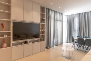 a living room with a large entertainment center with a television at Aria apartment 2 in Dhërmi