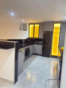 a kitchen with white and black appliances and yellow cabinets at Palmview in Bulawayo