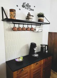 a kitchen with a black counter top and a shelf at Ferienwohnung Tutbach in Jünkerath