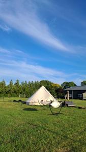 a tent in the middle of a field at Bell-tent Rosa met uitzicht in Hensbroek