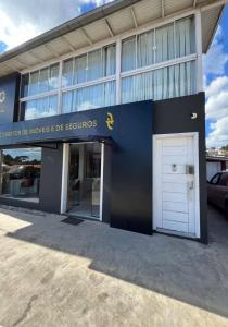a building with a white garage door in front of it at Incantare in São Joaquim