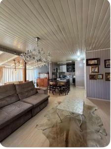a large living room with a couch and a table at Incantare in São Joaquim