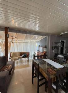 a living room with a table and a couch at Incantare in São Joaquim +11 photos