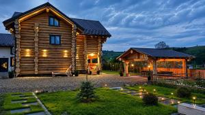 a log cabin with a gazebo at Derevo House in Yasinya