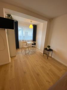 an empty living room with a table and chairs at Baltic Garden Stay in Kołobrzeg