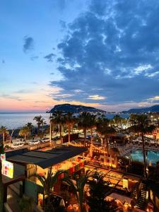 a view of a resort with a pool and palm trees at SA Apartments! Beachfront Apartments in Oba in Alanya