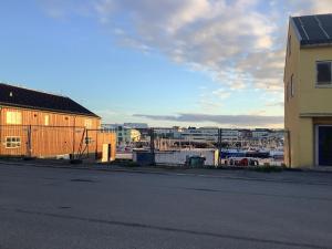 an empty street next to a building and a harbor at Ahmad sweet home in Vardø