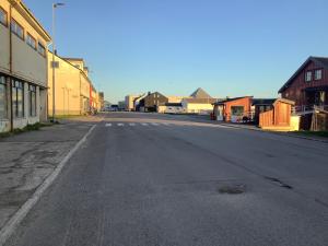 an empty street in a town with buildings at Ahmad sweet home in Vardø +14 photos