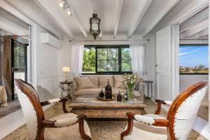 a living room with a table and chairs at Dar Almaz in Mijas
