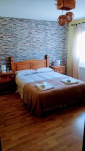 a bedroom with a large bed with two plates on it at El Pozo de la Cotarra in Cabezuela