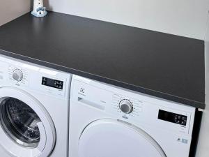 a white washing machine with a black counter above it at 5 star holiday home in MARSTRAND in Marstrand