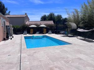 a swimming pool in the middle of a yard at Le cosy d'Aramon in Aramon