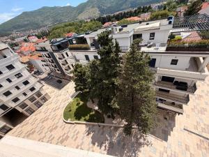 an apartment building with a tree in the middle at NOIR Luxury in Trebinje