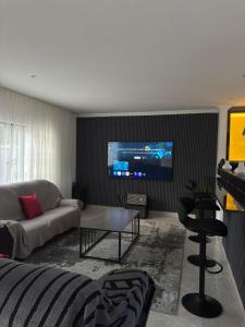 a living room with a couch and a tv at Palmview in Bulawayo