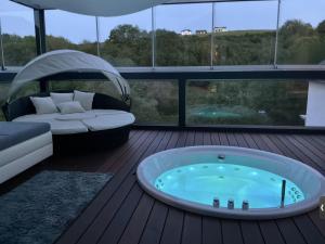 a jacuzzi tub on the deck of a house at Eifelloft&Spa in Adenau