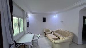 a living room with a couch and a table at House in Djerba s1 in Midoun