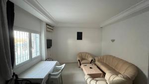 a living room with a couch and a table at House in Djerba s1 in Midoun