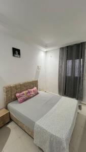 a bedroom with a large bed with a window at House in Djerba s1 in Midoun