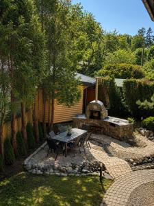 a patio with a table and a stone oven at Flower 18 in Jūrmala