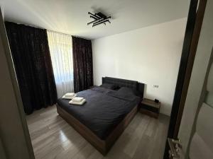 a bedroom with a bed with two towels on it at Anais Flower in Târgu Neamț